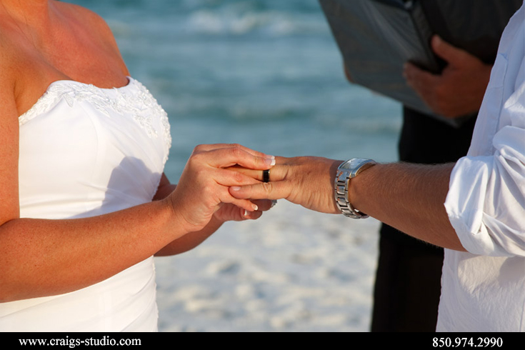 Brenda giving Brian his ring in a beach wedding in Destin, Florida